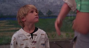 Movie still from “As Good as It Gets” (1997), directed by James L. Brooks – A young boy looking up at a person; Medium shot, Over the shoulder angle
