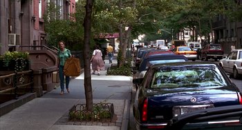 Movie still from “As Good as It Gets” (1997), directed by James L. Brooks – People walking down the sidewalk on a city street; Wide shot, High angle
