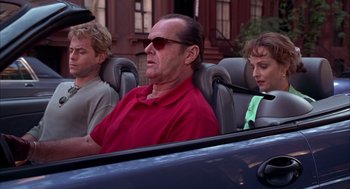 Movie still from “As Good as It Gets” (1997), directed by James L. Brooks – A man sitting in the back seat of a car with two other people; Medium shot, Over the shoulder angle