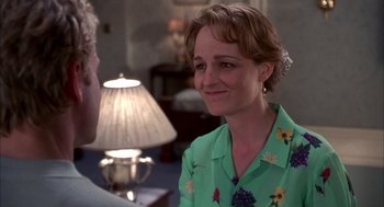 Movie still from “As Good as It Gets” (1997), directed by James L. Brooks – A woman in a green shirt talking to a man in front of a lamp; Close Up shot, Over the shoulder angle