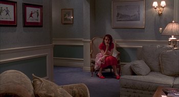 Movie still from “As Good as It Gets” (1997), directed by James L. Brooks – A woman sitting in a chair in a living room; Wide shot, High angle