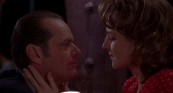 Movie still from “As Good as It Gets” (1997), directed by James L. Brooks – A man and a woman face to face in front of a wooden door; Close Up shot, Over the shoulder angle