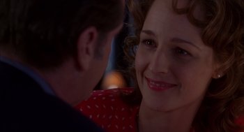Movie still from “As Good as It Gets” (1997), directed by James L. Brooks – A man and a woman smiling at each other; Close Up shot, Over the shoulder angle