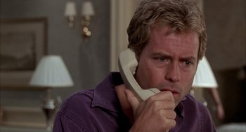 Movie still from “As Good as It Gets” (1997), directed by James L. Brooks – A man holding a phone up to his ear; Close Up shot, Low angle