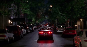 Movie still from “As Good as It Gets” (1997), directed by James L. Brooks – A street filled with lots of traffic at night; Extreme Wide shot, High angle