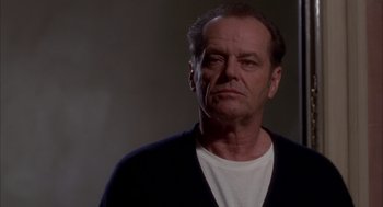 Movie still from “As Good as It Gets” (1997), directed by James L. Brooks – An older man with a white t - shirt and a black sweater; Close Up shot, Low angle