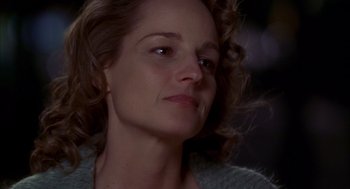 Movie still from “As Good as It Gets” (1997), directed by James L. Brooks – A woman's face in a dark room; Close Up shot, Low angle