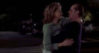 Movie still from “As Good as It Gets” (1997), directed by James L. Brooks – A man and a woman embracing on a street; Medium shot, Over the shoulder angle