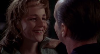 Movie still from “As Good as It Gets” (1997), directed by James L. Brooks – A woman smiling at a man with his hand on her shoulder; Close Up shot, Over the shoulder angle