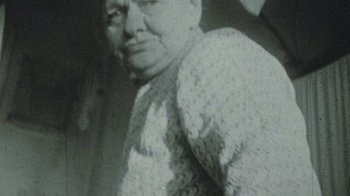 Movie still from “Assa” (1987), directed by Sergey Solovyov – An old photo of an older woman in a sweater; Close Up shot, High angle