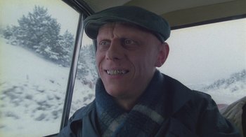 A person wearing a hat and scarf