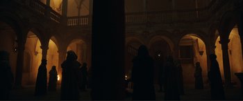 Movie still from “Assassin's Creed” (2016), directed by Justin Kurzel – A group of people standing in a building at night; Extreme Wide shot, Low angle