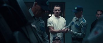 Movie still from “Assassin's Creed” (2016), directed by Justin Kurzel – A man standing in front of a group of people; Medium shot, Over the shoulder angle