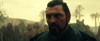 Movie still from “Assassin's Creed” (2016), directed by Justin Kurzel – A person with a beard; Close Up shot, Over the shoulder angle