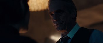 Movie still from “Assassin's Creed” (2016), directed by Justin Kurzel – A person wearing a suit and tie; Close Up shot, Over the shoulder angle