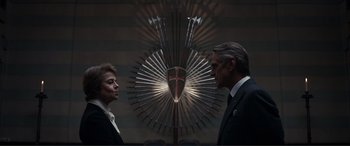 Movie still from “Assassin's Creed” (2016), directed by Justin Kurzel – A man and a woman standing next to each other in front of a cross; Medium shot, Over the shoulder angle