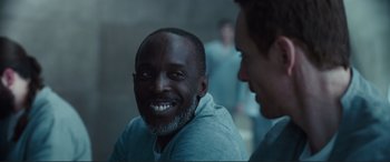 Movie still from “Assassin's Creed” (2016), directed by Justin Kurzel – A man with a big smile on his face; Close Up shot, Over the shoulder angle