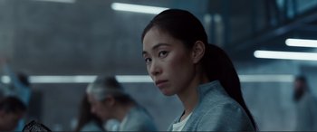 Movie still from “Assassin's Creed” (2016), directed by Justin Kurzel – A woman in a blue shirt is looking into the distance; Close Up shot, Low angle