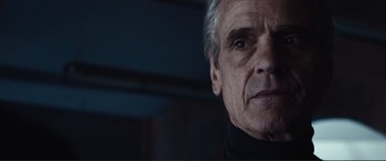 Movie still from “Assassin's Creed” (2016), directed by Justin Kurzel – An older man in a black shirt looking into the distance; Close Up shot, Over the shoulder angle