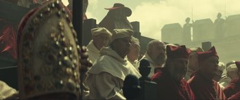 Movie still from “Assassin's Creed” (2016), directed by Justin Kurzel – A group of men in medieval garb are gathered together; Medium shot, Low angle
