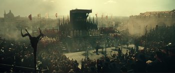 Movie still from “Assassin's Creed” (2016), directed by Justin Kurzel – A crowd of people sitting in a stadium; Extreme Wide shot, High angle