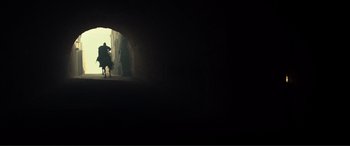 Movie still from “Assassin's Creed” (2016), directed by Justin Kurzel – Two people riding horses through a tunnel in the dark; Extreme Wide shot, Low angle