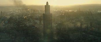 Movie still from “Assassin's Creed” (2016), directed by Justin Kurzel – A tall building with a tower on top of it in a city; Extreme Wide shot, High angle