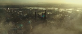 Movie still from “Assassin's Creed” (2016), directed by Justin Kurzel – An aerial view of a city with smoke coming out of it; Extreme Wide shot, Low angle