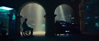 Movie still from “Assassin's Creed” (2016), directed by Justin Kurzel – A man sitting in a chair in front of an organ in a church; Wide shot, Low angle
