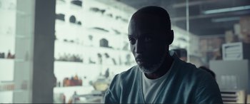 Movie still from “Assassin's Creed” (2016), directed by Justin Kurzel – A man in a white shirt is in front of shelves; Close Up shot, Low angle