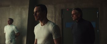 Movie still from “Assassin's Creed” (2016), directed by Justin Kurzel – A man standing next to another man in a room; Medium shot, Low angle