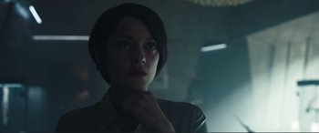 Movie still from “Assassin's Creed” (2016), directed by Justin Kurzel – A woman with short dark hair is looking into the distance; Close Up shot, Over the shoulder angle