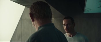 Movie still from “Assassin's Creed” (2016), directed by Justin Kurzel – A man standing in front of a mirror looking at himself in the mirror; Medium shot, Over the shoulder angle