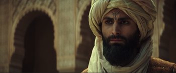 Movie still from “Assassin's Creed” (2016), directed by Justin Kurzel – A man with a beard wearing a turban; Close Up shot, Over the shoulder angle