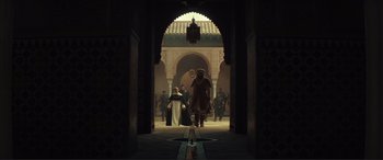 Movie still from “Assassin's Creed” (2016), directed by Justin Kurzel – A group of people walking through an archway; Extreme Wide shot, Low angle