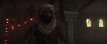 Movie still from “Assassin's Creed” (2016), directed by Justin Kurzel – A man with a beard wearing a turban; Medium shot, Low angle