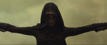 Movie still from “Assassin's Creed” (2016), directed by Justin Kurzel – A person in a hooded jacket and a black hood; Medium shot, Low angle