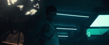 Movie still from “Assassin's Creed” (2016), directed by Justin Kurzel – A man holding a tennis racquet in a dark room; Medium shot, Low angle