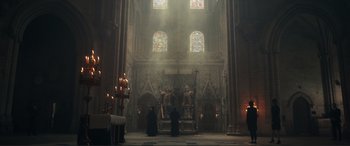 Movie still from “Assassin's Creed” (2016), directed by Justin Kurzel – A priest is standing in front of the alter in a church; Extreme Wide shot, Low angle