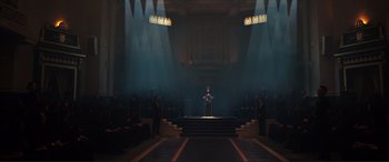 Movie still from “Assassin's Creed” (2016), directed by Justin Kurzel – A man standing at the top of a stage with a microphone; Extreme Wide shot, Low angle