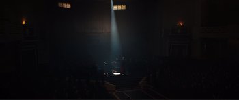 Movie still from “Assassin's Creed” (2016), directed by Justin Kurzel – A person standing on a stage in a dark room; Extreme Wide shot, High angle