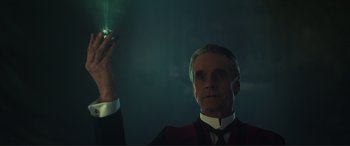 Movie still from “Assassin's Creed” (2016), directed by Justin Kurzel – A man in a suit and tie holding a cigarette in his right hand; Close Up shot, Low angle