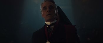 Movie still from “Assassin's Creed” (2016), directed by Justin Kurzel – An older man wearing a suit and a medal; Close Up shot, Low angle
