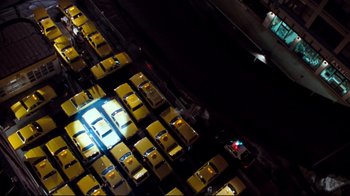 Movie still from “Assassins” (1995), directed by Richard Donner – An aerial view of a parking lot filled with yellow cabs; Extreme Wide shot, Overhead angle