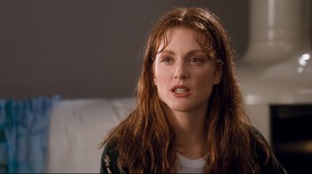 Movie still from “Assassins” (1995), directed by Richard Donner – A person sitting on a couch; Close Up shot, Over the shoulder angle