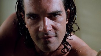 Movie still from “Assassins” (1995), directed by Richard Donner – A person with wet hair; Close Up shot, Low angle