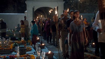 Movie still from “Assassins” (1995), directed by Richard Donner – A group of people standing next to candles; Wide shot, High angle