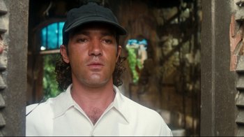 Movie still from “Assassins” (1995), directed by Richard Donner – A person wearing a hat; Close Up shot, Low angle