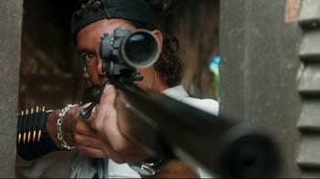 Movie still from “Assassins” (1995), directed by Richard Donner – A man is holding a rifle and aiming at something; Close Up shot, Low angle