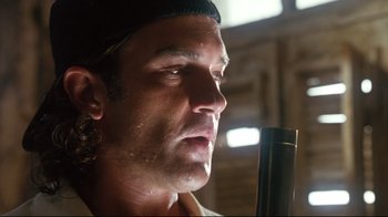 Movie still from “Assassins” (1995), directed by Richard Donner – A person with a microphone; Close Up shot, Low angle